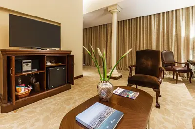 a living room with a television and a table and a chair at Country Club Lima Hotel – The Leading Hotels of the World in Lima