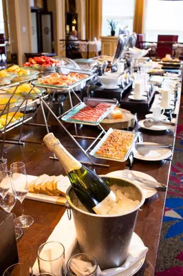 a long table with a bottle of champagne in a bucket at Country Club Lima Hotel – The Leading Hotels of the World in Lima