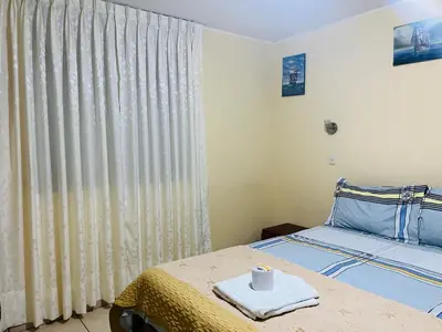 a bedroom with a bed and a window with curtains at Sandel in Barranca