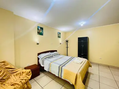 a bedroom with a bed and a chair in it at Sandel in Barranca