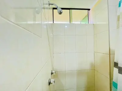 a shower with a shower head in a bathroom at Sandel in Barranca