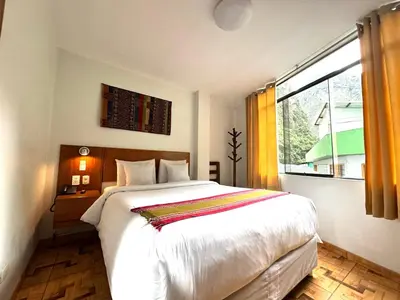 a bedroom with a large bed and a window at Mantu Boutique in Machu Picchu