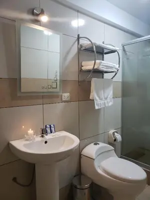a bathroom with a sink and a toilet and a mirror at Mantu Boutique in Machu Picchu