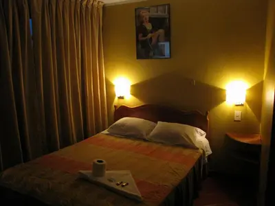 a bedroom with a bed with two lamps and a tray on it at Prince Hospedaje in Ayacucho