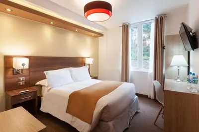 a hotel room with a large bed and a window at Inti Punku Machupicchu Hotel & Suites in Machu Picchu