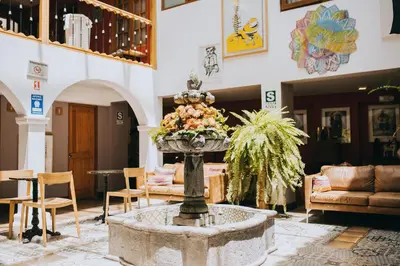 a lobby with a fountain in the middle of a room at Anden Inca Hotel in Cusco