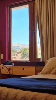 a bedroom with a bed and a window with a view at Anden Inca Hotel in Cusco