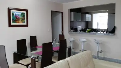 a dining room and kitchen with a glass table and chairs at Condominio Las Terrazas in Asia