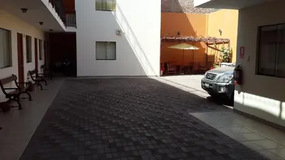 a hallway with a car parked next to a building at Hotel La Casona in Pisco
