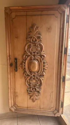 a wooden door with a carving on it at Hotel La Casona in Pisco