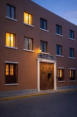 a large brick building with a wooden door at Hotel La Casona in Pisco