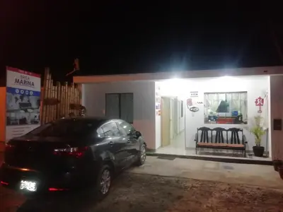 a car parked in front of a house at night at Hostal Brisa Marina in Paracas