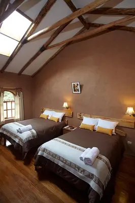 a bedroom with two beds in a room at Willka Rumi in Urubamba