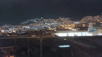 a view of a city at night with lights at Kutty Wasi in Cusco