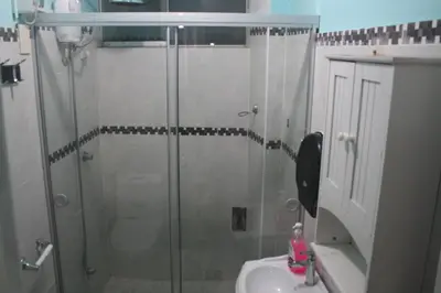 a bathroom with a glass shower and a sink at Main Square in Lima