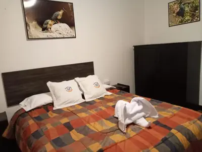 a bedroom with a bed with towels on it at Qoricancha B&B Cusco in Cusco