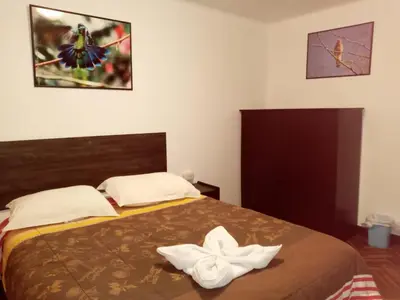 a bedroom with a bed with two white towels on it at Qoricancha B&B Cusco in Cusco