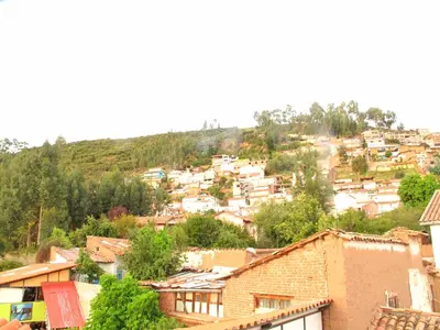 a town on a hill with houses and trees at Casa De Mama Cusco - The Treehouse in Cusco