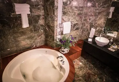 a bathroom with a bath tub and a sink at Aranwa Cusco Boutique Hotel in Cusco