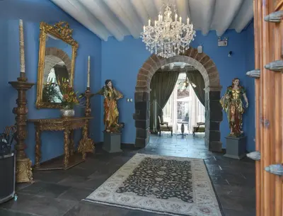 a hallway with blue walls and a chandelier at Aranwa Cusco Boutique Hotel in Cusco
