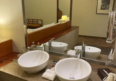 a bathroom with two sinks and a large mirror at Aranwa Sacred Valley Hotel & Wellness in Urubamba