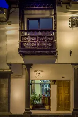 a building with a balcony and a door at Katari Plaza Cusco El Virrey in Cusco