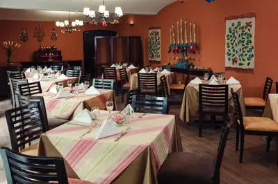 a dining room with several tables and chairs at LP Los Portales Hotel Cusco in Cusco
