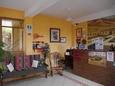 a room with two chairs and a counter in a store at Hostal Tambo Colorado in Pisco