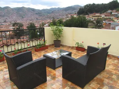 a balcony with chairs and a table with a view at Best View apartment downtown Cusco in Cusco