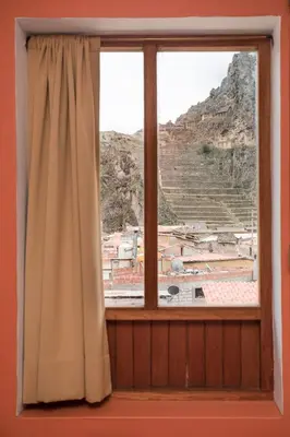 a window with a view of a mountain at SAUCE Hotel Boutique in Ollantaytambo