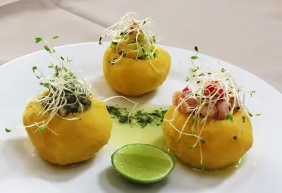 a plate of food with a lime on it at Hotel Villa Urubamba in Urubamba