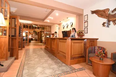 a lobby of a pharmacy with two people at a counter at Hotel Prisma Cusco in Cusco