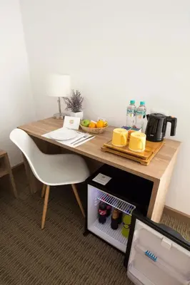 a wooden table with a bowl of fruit and water on it at Tierra Viva Miraflores Mendiburu in Lima