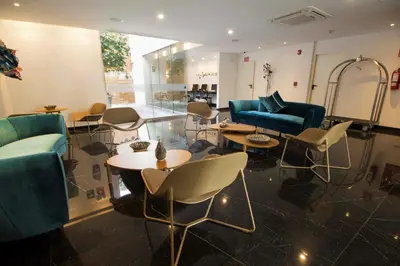 a lobby with couches and tables and chairs at Tierra Viva Miraflores Mendiburu in Lima