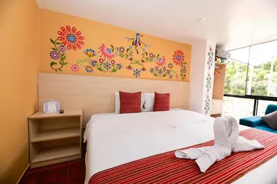 a bedroom with a bed with a flower mural on the wall at Mayu Boutique Hotel in Cusco