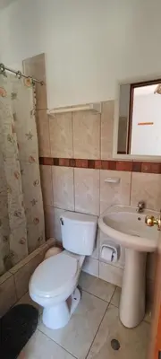 a bathroom with a toilet and a sink at Casa de Campo Chinkay - Lunahuana in Lunahuaná