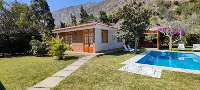 a small house with a swimming pool in a yard at Casa de Campo Chinkay - Lunahuana in Lunahuaná