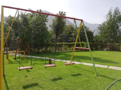 an empty playground with swings in a park at Casa de Campo Chinkay - Lunahuana in Lunahuaná