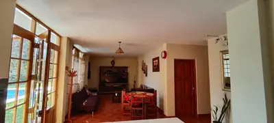 a living room with a table and a dining room at Casa de Campo Chinkay - Lunahuana in Lunahuaná
