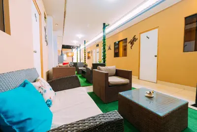 a lobby with couches and chairs and a table at Hospedaje Mary in Paracas