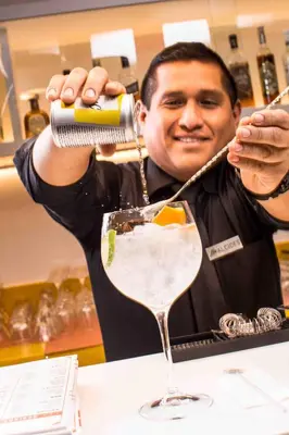 a man is preparing a drink in a cocktail at Libre Hotel, BW Signature Collection by Best Western in Lima