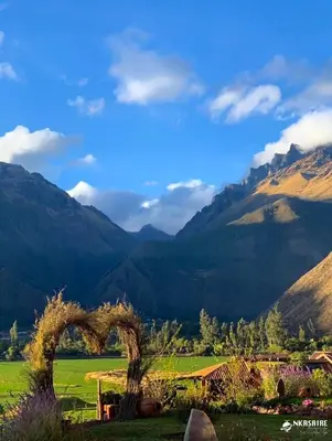 a view of a field with mountains in the background at Inkasaire Boutique Lodge in Urubamba