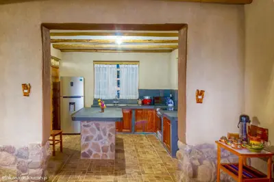 a kitchen with a island in the middle of a room at Inkasaire Boutique Lodge in Urubamba