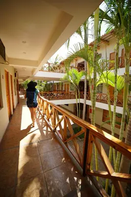 a person walking down a hallway with an umbrella at Casa Andina Standard Nasca in Nazca