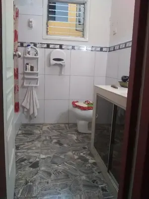 a bathroom with a toilet and a sink at Hospedaje Marita in Lima