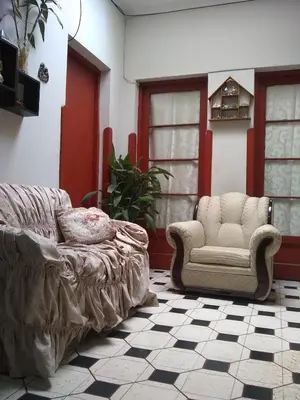 a living room with a couch and a chair at Hospedaje Marita in Lima