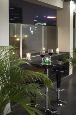 two wine glasses sitting on a table with candles at El Angolo in Lima