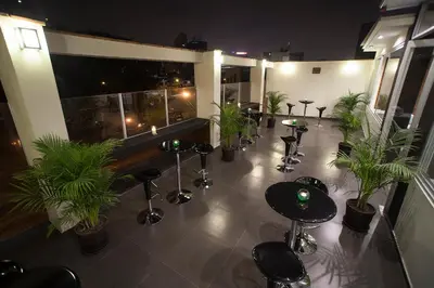 a room with a bunch of plants and tables at El Angolo in Lima