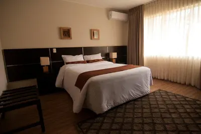 a bedroom with a large bed and a window at Tambo Dos de Mayo in Lima