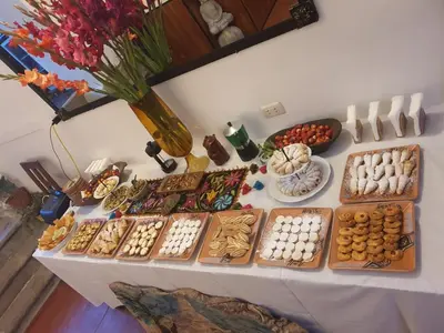 a table with many different types of pastries and cookies at Casona Mollepata in Mollepata